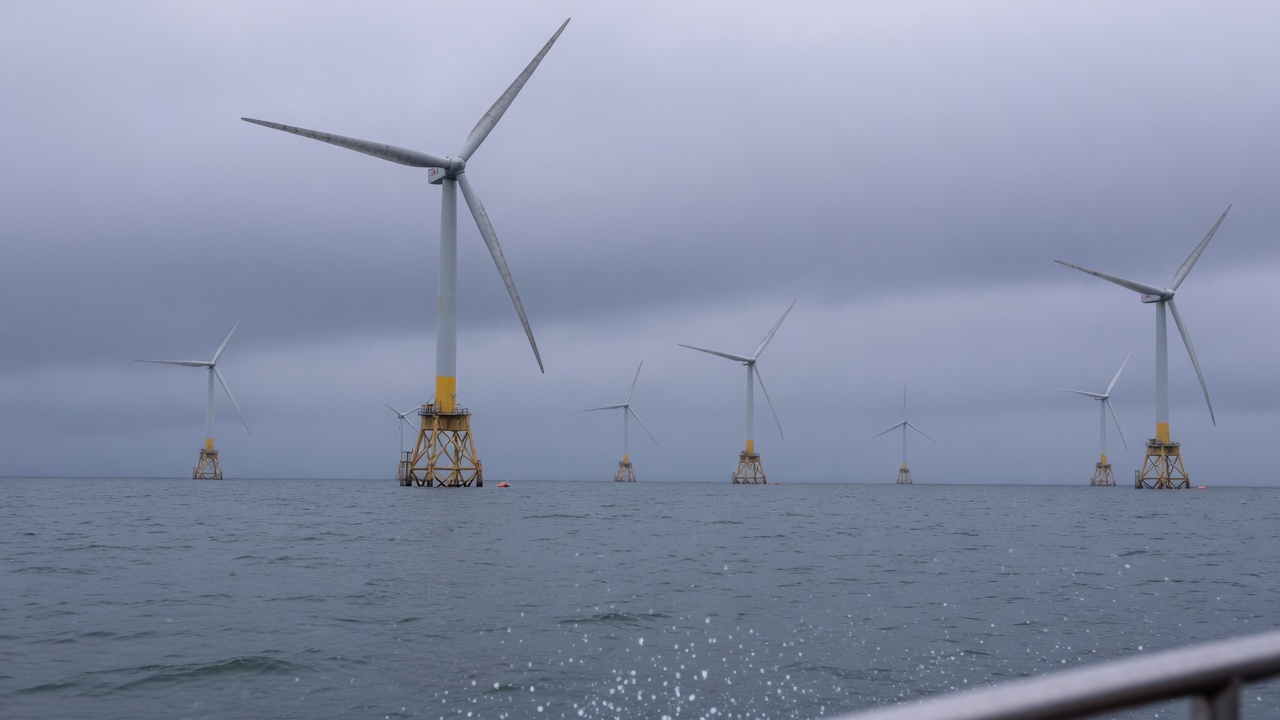 Offshore wind turbines in a grey sea under overcast sky